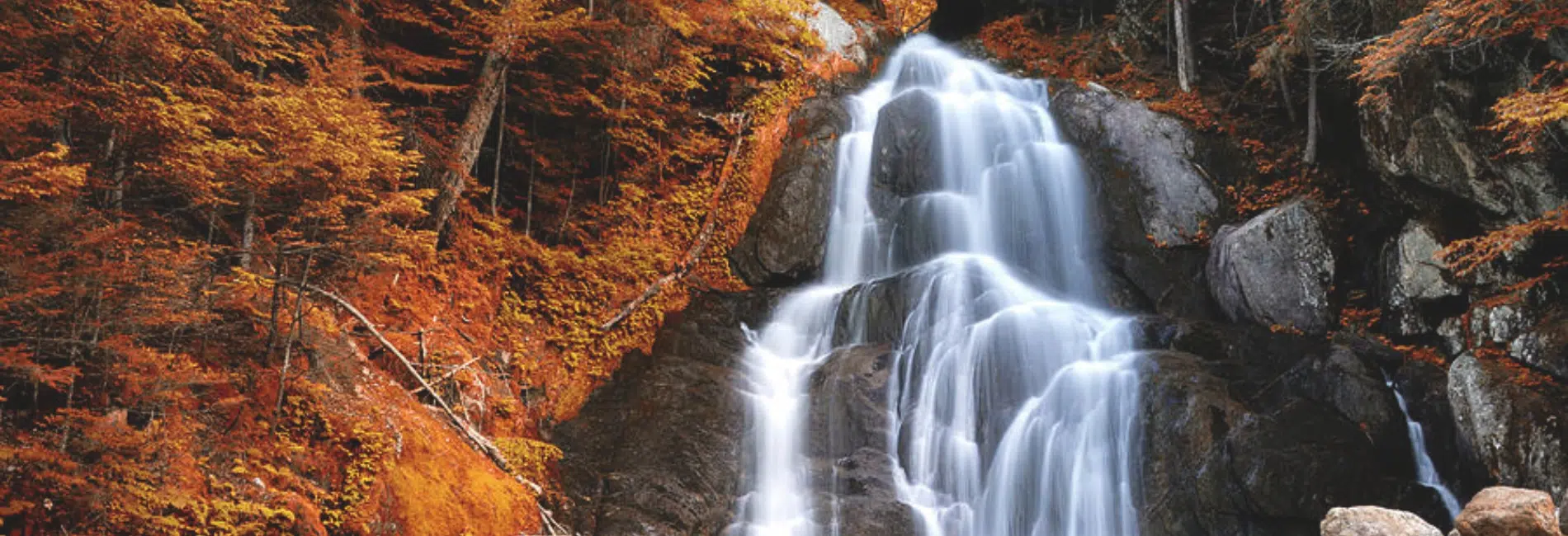 Moss Glen Falls surrounded by fall foliage