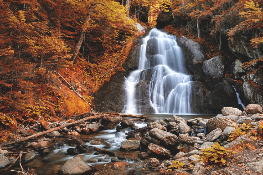 Moss Glen Falls surrounded by fall foliage